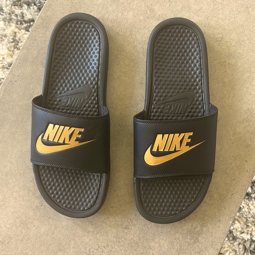 Only worn once mens nike slides. Great condition like new. Black and Gold.